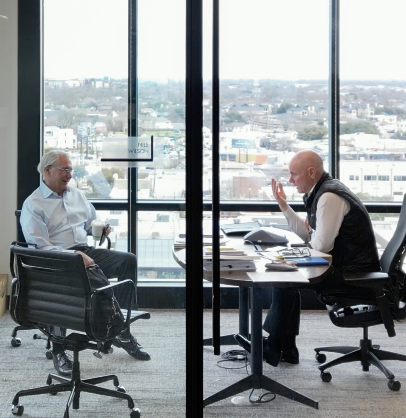 Photo of two people at conference table